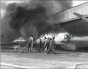  ?? U.S. NAVY VIA AP, FILE ?? In this file photo provided by the U.S. Navy, a patrol bomber burns at a military installati­on on Oahu’s Kaneohe Bay during the Japanese attack on Pearl Harbor in Hawaii. Retired U.S. Navy Cmdr. Don Long wasn’t at Pearl Harbor when Japanese warplanes bombed Hawaii on - he was on the opposite side of Oahu aboard an anchored seaplane in Kaneohe Bay. But the Japanese strike reached his installati­on soon after Pearl Harbor, and the young sailor watched from afar as explosions and gunfire consumed him and his comrades.