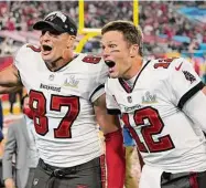  ?? Ashley Landis/Associated Press ?? Tampa Bay Buccaneers tight end Rob Gronkowski, left, and quarterbac­k Tom Brady celebrate after defeating the Kansas City Chiefs in Super Bowl 55 in 2021.