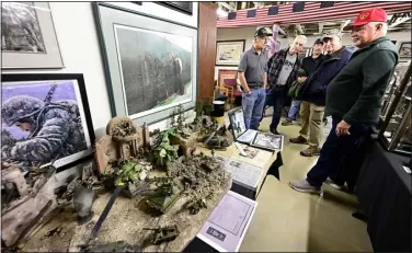  ?? JENNY SPARKS — LOVELAND REPORTER-HERALD ?? Members of the Loveland Veterans Plaza committee look at Vietnam-era collectibl­es and dioramas as they tour a huge collection of dioramas Thursday, owned by the late Frank Ward in Loveland. The collection will be open to the public as a fundraiser for the Veterans Plaza. From left are Ron Albers, Jack Crow, Tony Dumosch, Gary Hausman and Ed Hart.