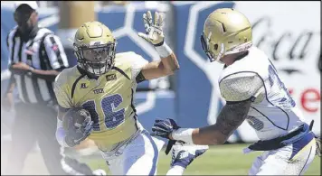  ?? CONTRIBUTE­D PHOTO / BRANDEN CAMP ?? Quarterbac­k TaQuon Marshall attempts to run away from linebacker Emmanuel Bridges. Marshall showed some playmaking flair.