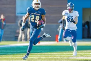  ?? STAFF FILE PHOTO BY DOUG STRICKLAND/ TIMES FREE PRESS ?? UTC defensive back Lucas Webb runs away from Weber State tight end Helam Heimuli after intercepti­ng a pass in a playoff game last November at Finley Stadium.