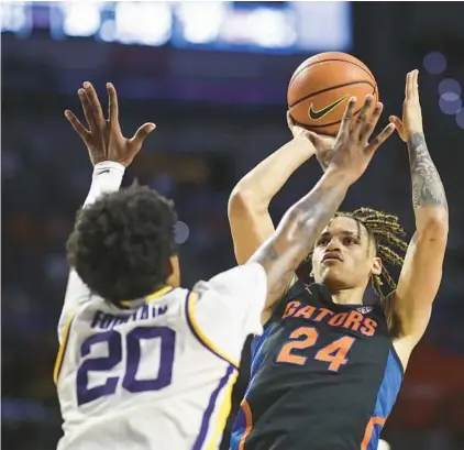  ?? GILBERT/GETTY JAMES ?? Florida freshman Riley Kugel, of Orlando, shoots over LSU’s Derek Fountain en route to 21 points in the Gators’ March 4 win in Gainesvill­e.