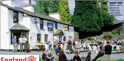  ??  ?? DROP INN: Hikers take a deserved break at a pub in the Lake District