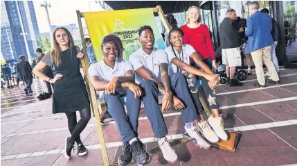  ??  ?? > Eliza Hakes and Ruth Griffin (standing, both Gowling WLG) with athletes Ama Agbeze (netball), Kofi Josephs (basketball) and Abazz Shayaam-Smith (triple jump) outside the Library of Birmingham