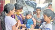 ?? HT FILE ?? Oneyearold Chahat. who weighs nearly 20kg, with her mother and children of her locality in Amritsar.