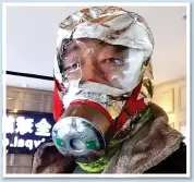  ??  ?? DESPERATE MEASURES: Masks in China made of tin foil and tape, left, and a grapefruit skin