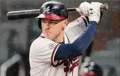  ?? John Bazemore / Associated Press ?? Freddie Freeman might become an even more attractive free agent to National League teams who now know that if he slows down in the field, they can keep his bat in the lineup with the NL adopting the designated hitter rule.