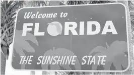  ?? BILL MANNING/GETTY ?? While Florida’s highway centers were once known for offering free orange juice to weary travelers, state workers at the reopened facilities are providing free face masks as part of COVID-19 protocols.