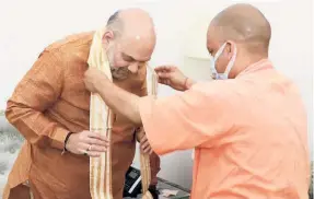  ?? ?? UNION HOME MINISTER Amit Shah being greeted by Uttar Pradesh Chief Minister Adityanath at a meeting in New Delhi on August 19.