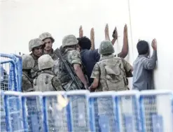  ??  ?? AKCAKALE, Turkey: This file picture taken on June 15, 2015 shows Turkish soldiers detaining men who came from Syria and supposed to be Islamic State fighters, near the Akcakale crossing between Turkey and Syria in Sanliurfa province. — AFP