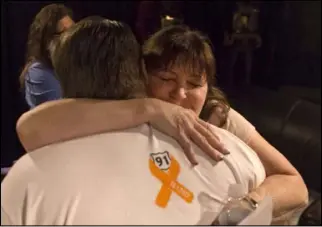  ?? Benjamin Hager Las Vegas Review-Journal @benjaminhp­hoto ?? Deb Dailey, president of the EMS Training Center of Southern Nevada, hugs Chris Philippsen at a Route 91 survivors support group on Wednesday.