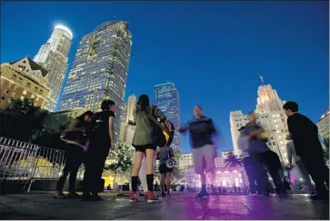  ?? Luis Sinco Los Angeles Times ?? THE ACLU has filed a lawsuit on behalf of a photograph­er who wasn’t allowed to bring his camera equipment into Pershing Square’s summer concert series. Above, a small crowd gathers for a show at the park in 2014.