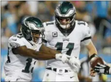  ?? BOB LEVERONE — THE ASSOCIATED PRESS ?? The Eagles’ Nelson Agholor (13) celebrates his touchdown catch with quarterbac­k Carson Wentz (11) in the second half in Charlotte, N.C., Thursday.