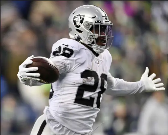  ?? CAEAN COUTO — THE ASSOCIATED PRESS ?? Raiders running back Josh Jacobs celebrates as he scores the game-winning touchdown during overtime Sunday vs. the Seahawks in Seattle.