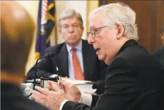  ?? J. Scott Applewhite / Associated Press ?? Senate Minority Leader Mitch McConnell of Kentucky (right) speaks as Sen. Roy Blunt, RMo., listens during a Senate Rules Committee hearing at the Capitol.