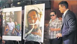  ??  ?? GONZALEZ and Mardirossi­an stand next to photos of Valenzuela on life support in an Anaheim hospital and with his two children, Ximena, 5, and Fermin III, 9.