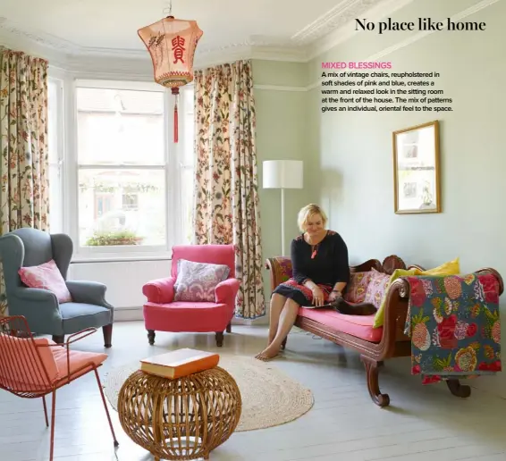 ??  ?? MIXED BLESSINGS A mix of vintage chairs, reupholste­red in soft shades of pink and blue, creates a warm and relaxed look in the sitting room at the front of the house. The mix of patterns gives an individual, oriental feel to the space.