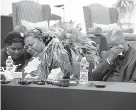  ?? BILL PUGLIANO/GETTY ?? Dorcas Lyoya, center, and Peter Lyoya mourn the death of their 26-year-old son, Patrick, at a news conference Thursday in Grand Rapids, Mich. He was killed April 4.