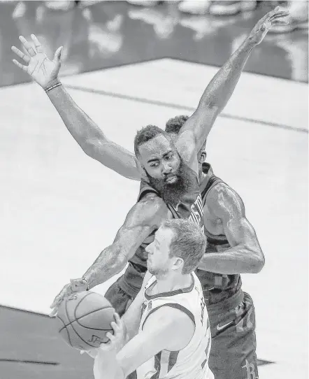  ?? Michael Ciaglo / Houston Chronicle ?? Rockets guard James Harden extends himself to try to thwart a pass by Jazz forward Joe Ingles, foreground, during Game 2.