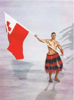  ?? Jamie Squire, Getty Images ?? Pita Taufatofua is shirtless again as he leads Tonga’s Olympic team at the opening ceremony in frigid PyeongChan­g. Taufatofua drew attention for the same attire at the much warmer Rio Games.