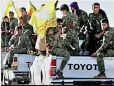  ??  ?? Fighters of Syrian Democratic Forces ride on trucks as their convoy passes inAin Issa, Syria.