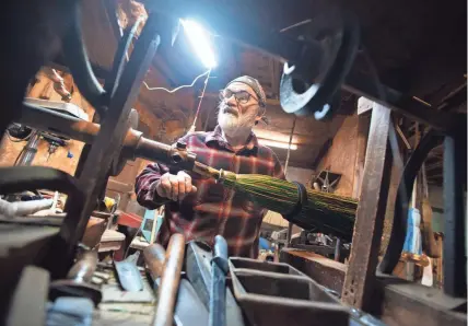  ?? PHOTOS BY JAMAR COACH/JACKSON SUN ?? Broom-maker Jack Martin looks for a special tool to finish off the broomcorn inside Hockaday Brooms in Selmer on Mar. 8.