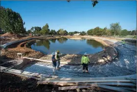  ?? NWA Democrat-Gazette/SPENCER TIREY ?? A constructi­on crew works on laying rebar Friday as they work to create walls and improve Murphy Park’s pond in Springdale.