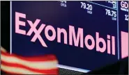  ?? (AP/Richard Drew) ?? Despite a $610 million loss, Exxon Mobil maintained a quarterly dividend of 87 cents per share, and chief executive Darren Woods assured investors that the dividend is a priority for the company.