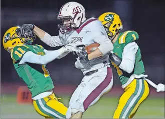  ?? SEAN D. ELLIOT/THE DAY ?? East Lyme’s Scott Galbo (40) breaks free from New London’s Donovan Jeffcoat (11) and Jaylen Callender for a touchdown in Friday’s game at Cannamela Field in New London.