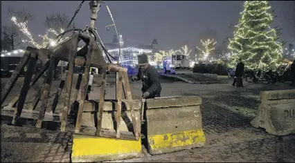  ?? PETER DEJONG / AP ?? Concrete barriers are being moved to enlarge the security perimeter near the Christmas market in Amsterdam, Netherland­s, on Tuesday following the attack in Berlin, Germany.