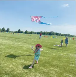  ?? GILES BRUCE/NAPERVILLE SUN ?? Six-year-old Adaline Filip, of Naperville, flies a Little Mermaid kite Sunday at Frontier Sports Complex during the annual Kite Fly.