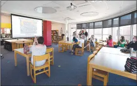  ?? (NWA Democrat-Gazette/J.T. Wampler) ?? Teachers and administra­tors gather Thursday in the library at Bernice Young Elementary School in Springdale as it was announced the school was recognized as a National Blue Ribbon School for 2020. The recognitio­n comes from the U.S. Department of Education and is based on the school’s overall academic performanc­e or progress in closing achievemen­t gaps among student subgroups. Go to nwaonline.com/200925Dail­y/ and nwadg.com/photos for more photos.