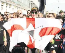  ??  ?? The proud Northern Irishman waves his national flag in France