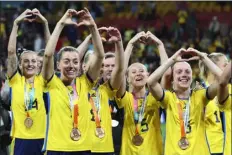  ?? PHOTOS BY TERTIUS PICKARD — THE ASSOCIATED PRESS ?? Sweden players gesture to supporters as they celebrate with their bronze medals after defeating Australia in the Women’s World Cup third-place match on Saturday in Brisbane, Australia.
