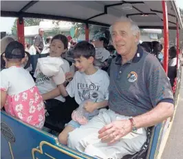  ?? STAFF FILE PHOTO ?? Henri Landwirth, founder of Give Kids The World, right, and children prepare to ride the train around the Give Kids The World village in 1998 in Kissimmee.