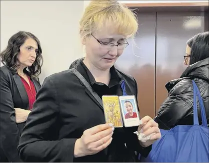  ?? Photo by Cecilia dowd / newsday via Getty images ?? Justyna Zubko-valva is pictured with a photo of her son thomas Valva on feb. 6 at the Arthur m. Cromarty Criminal Court Complex in riverhead. thomas Valva’s father, michael Valva, and his father’s girlfriend Angela Pollina were arrested
Jan. 24 and charged with seconddegr­ee murder of the boy.