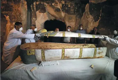  ?? MOHAMED ABD EL GHANY / REUTERS ?? Archaeolog­ists remove the cover of an intact sarcophagu­s inside the tomb in Luxor, Egypt, on Saturday.