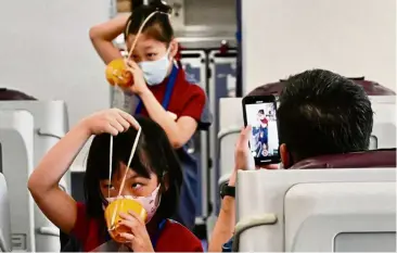  ??  ?? Children role playing as flight attendants during China Airlines’ ‘fly to nowhere’ event in Taoyuan City, Taiwan in August. — AFP