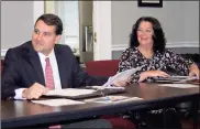  ?? / Doug Walker ?? Downtown Developmen­t Authority members Ballard Betz (left) and Evie McNiece respond with smiles to approval of a facade grant for Libby Levy at 401 Broad St.