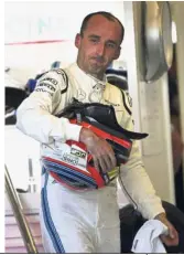  ?? — AP ?? Getting into the action: Williams reserve driver Robert Kubica of Poland getting out of his car after the first free practice at the Yas Marina racetrack in Abu Dhabi yetserday.