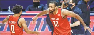  ?? MICHAEL HICKEY/ GETTY ?? Maryland’s Marcus Dockery and Galin Smith celebrate Sunday’s 66- 63 win over Illinois.