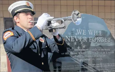  ?? AP PHOTO ?? John Pristas, a firefighte­r for the Cranberry Township Volunteer Fire Company, blows “Taps” on a trumpet Monday during a 16th anniversar­y ceremony marking the terrorist attacks at their 9-11 Memorial in front of the station in Cranberry, Pa.