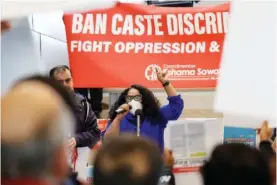  ?? AP PHOTO/JOHN FROSCHAUER ?? Thenmozhi Soundarara­jan, founder and executive director of Equality Labs, speaks Tuesday to supporters and opponents a of a proposed ordinance to add caste to Seattle’s anti-discrimina­tion laws rally at Seattle City Hall in Seattle.