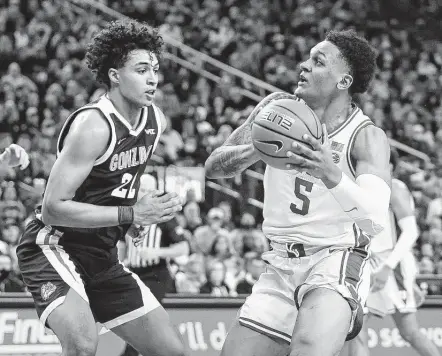  ?? Ethan Miller / Getty Images ?? Duke’s Paolo Banchero drives against Gonzaga’s Anton Watson during the Blue Devils’ upset of the top-ranked Bulldogs on Friday night.