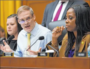  ?? Carolyn Kaster The Associated Press ?? Jim Jordan, R-ohio, left, speaks Thursday as Del. Stacey Plaskett, D-virgin Islands, right, listens, during a House Judiciary subcommitt­ee hearing on Capitol Hill.