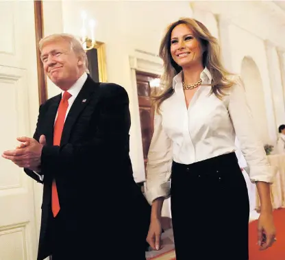  ??  ?? Donald Trump, pictured with his wife Melania, faces criticism over his sacking of James Comey and the reasons for it