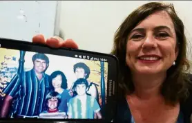  ??  ?? Those were the days: Twomey showing a photograph of her family with Sai.
