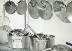  ?? KYLE TELECHAN/POST-TRIBUNE ?? Pots, pans, and utensils sit ready to be used on wire racks at the Hammond Developmen­t Corp. Community Kitchen on Thursday.