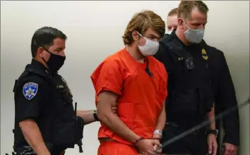  ?? Matt Rourke/Associated Press ?? Payton Gendron is led into the courtroom for a hearing at Erie County Court on May 19 in Buffalo, N.Y. Mr. Gendron faces charges in the May 14 fatal shooting at a supermarke­t.