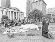  ?? DYLAN LOVAN/AP ?? A protester prays Sunday in Louisville, Kentucky. A man was killed Saturday protesting Breonna Taylor’s death.